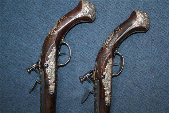 A pair of 18th century Bavarian flintlock holster pistols by Johann Jacob Kuchenreuter, overall length 21.5in.